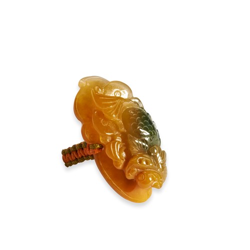 105 - TWO CARVED JADEITE RINGSA white and green coloured jadeite ring in the form of a carved dragon on a ... 