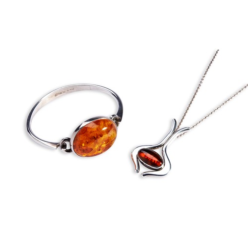 86 - N.E. FROM, DENMARK, BRACELET AND PENDANTA silver bracelet set with a large amber cabochon with hook ... 