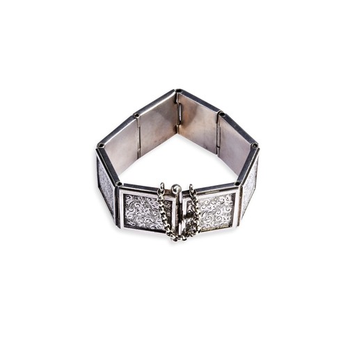 89 - A VICTORIAN BRACELET, CIRCA 1890 of eight articulated panels with a chased central design. Unmarked ... 