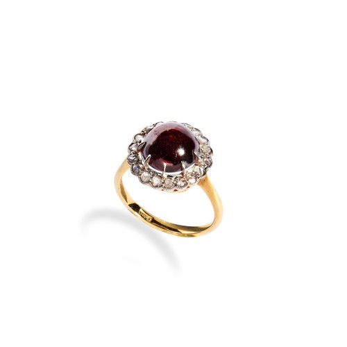 122 - GARNET AND ROSE CUT DIAMOND RINGset with a large claw set garnet cabochon surrounded by a halo or sm... 