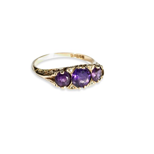 123 - AMETHYST AND DIAMOND RING Three amythyst and four diamond highlights set in a carved head.Size P 1/2... 