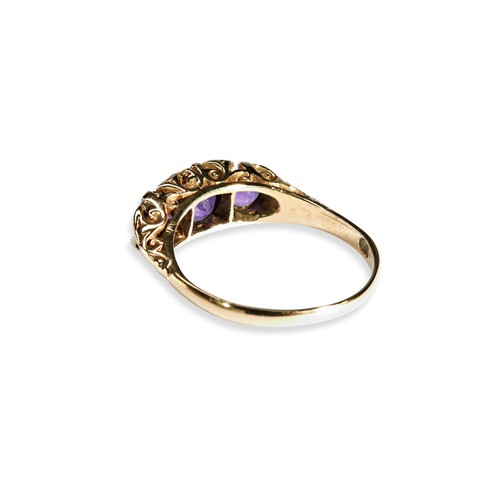 123 - AMETHYST AND DIAMOND RING Three amythyst and four diamond highlights set in a carved head.Size P 1/2... 