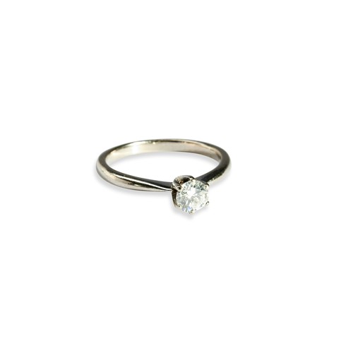 119 - A SINGLE STONE DIAMOND RING with a claw set diamond between a tapering shank. Set in white metal. Ri... 