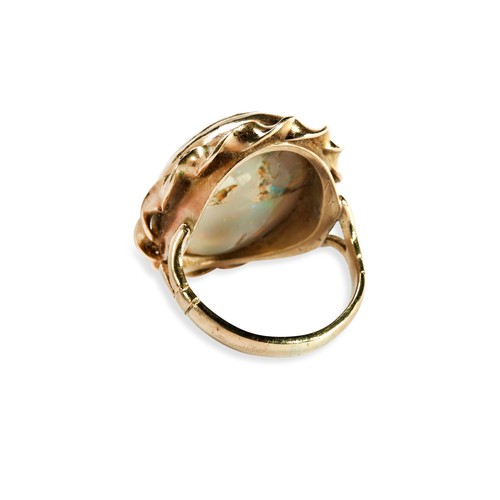 120 - AN OPAL RING the oval cabochon-cut opal set within a twisted border and split shank. Ring size I. Un... 