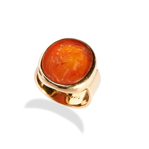 139 - A CARNELIAN AND GOLD RING, CIRCA 1800-1850  the oval carnelian intaglio of a bacchante, within a hea... 