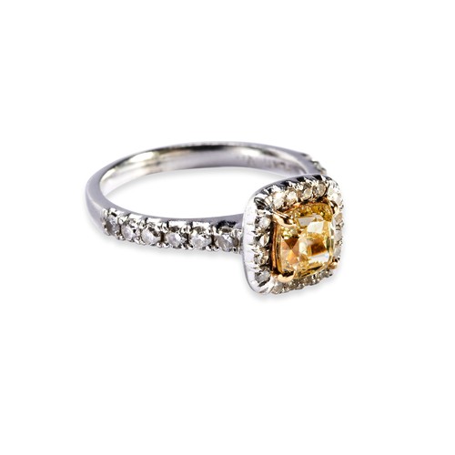 112 - A FANCY INTENSE YELLOW DIAMOND RING the modified square brilliant-cut yellow diamond, weighing 1.02 ... 