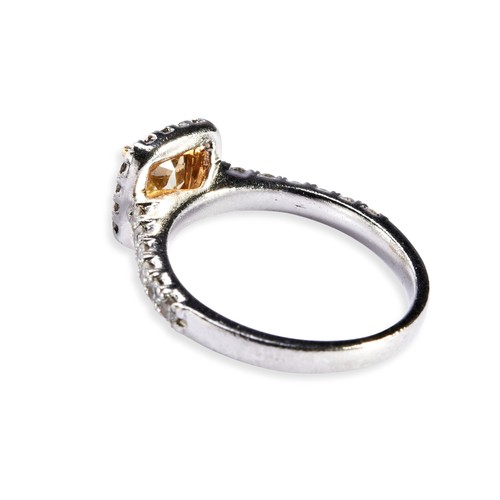 112 - A FANCY INTENSE YELLOW DIAMOND RING the modified square brilliant-cut yellow diamond, weighing 1.02 ... 