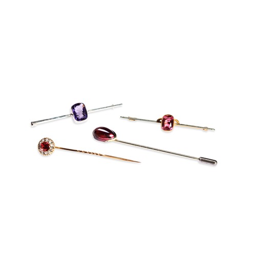 146 - A LATE NINETEENTH CENTURY GARNET TIE PIN  the pear shaped cabochon-cut garnet in plain gold setting ... 