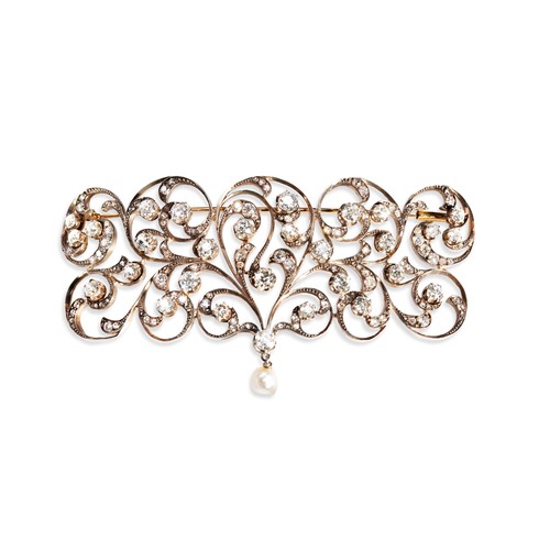 150 - A DIAMOND BROOCH, CIRCA 1880/1900 the elaborate slightly arched diamond set scrolling frame, set thr... 