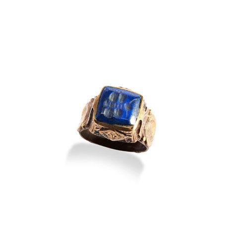 136 - A PERSIAN/BYZANTINE POLISHED BRONZE RING, the raised square top inset with a lapis stone engraved wi... 