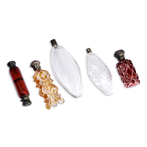 253 - A COLLECTION OF GLASS PERFUME BOTTLES.Two clear cut glass flask shaped bottles with white metal lids... 