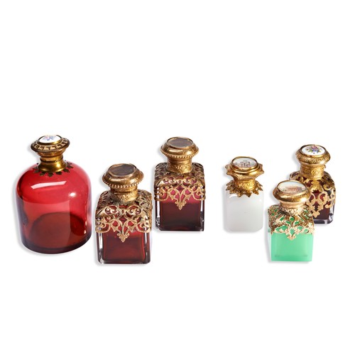 251 - A COLLECTION OF 19TH AND 20TH CENTURY CONTINENTAL GLASS SCENT BOTTLEfive with gilt metal filigree mo... 