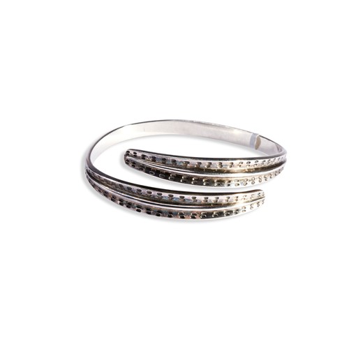 165 - A SILVER BANGLE, SAGA RANGE DAVID ANDERSEN of torque design with oval stamped decoration to the... 