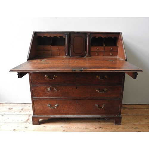 32 - A GEORGIAN III OAK BUREAU, witha sloping fall above four graduated drawers, on bracket feet, the int... 