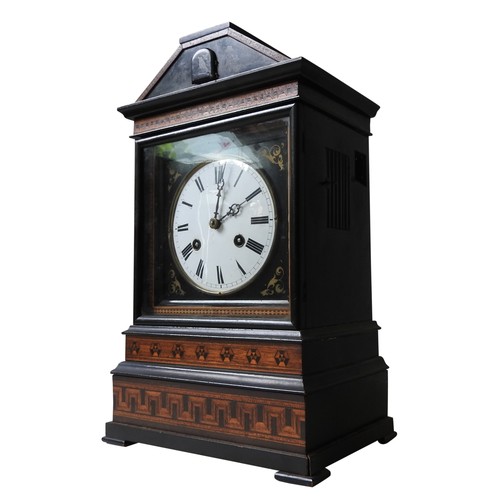 A 19TH CENTURY MANTEL CUCKOO CLOCK, with a double fusee movement, enamelled dial with Roman numerals, in a ebonised case with Tunbridgeware frieze decoration, with pendulum and key,  46 x 29 x 19 cm