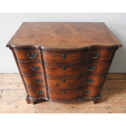 40 - AN EDWARDIAN WALNUT AND MAHOGANY SERPENTINE CHEST OF DRAWERS, in a George II style , with an inlaid ... 