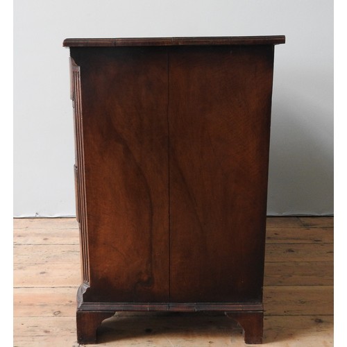 40 - AN EDWARDIAN WALNUT AND MAHOGANY SERPENTINE CHEST OF DRAWERS, in a George II style , with an inlaid ... 