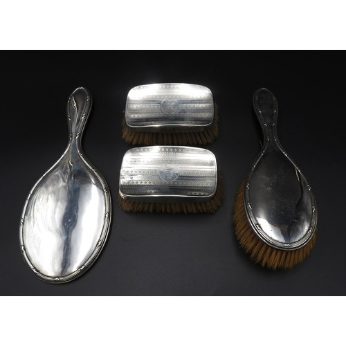 451 - A VINTAGE SILVER HAND MIRROR, MATCHING BRUSH AND TWO OTHER SILVER BRUSHES,