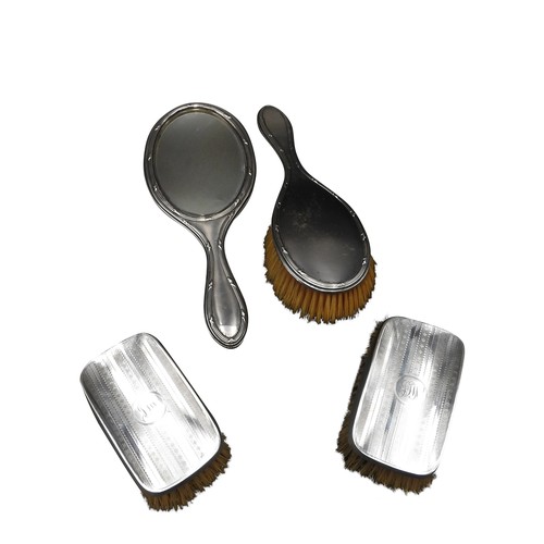 451 - A VINTAGE SILVER HAND MIRROR, MATCHING BRUSH AND TWO OTHER SILVER BRUSHES,