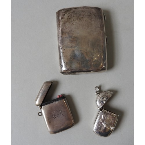 452 - TWO EDWARDIAN SILVER VESTA CASES AND A SILVER CIGARETTE CASE, one vesta case monogrammed, the other ... 