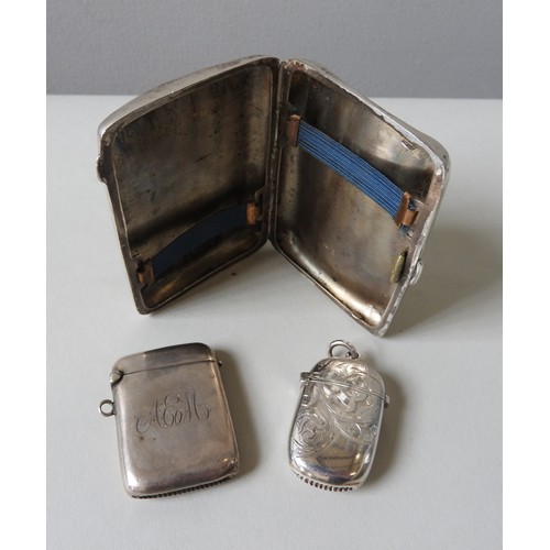 452 - TWO EDWARDIAN SILVER VESTA CASES AND A SILVER CIGARETTE CASE, one vesta case monogrammed, the other ... 