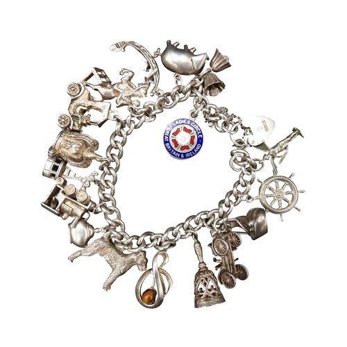 455 - A SILVER CHARM BRACELET, with sixteen assorted charms attached, total weight 72 grams