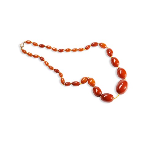 531 - A QUANTITY OF NECKLACESTwo dark orange graduating beaded bakelite necklaces. Together with three ora... 