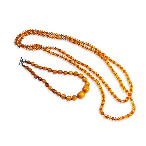 531 - A QUANTITY OF NECKLACESTwo dark orange graduating beaded bakelite necklaces. Together with three ora... 