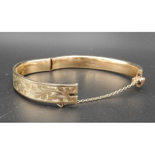 534 - A 9CT GOLD SLAVE BANGLE, partially decorated with foliate pattern, stamped .375, 11.5 grams