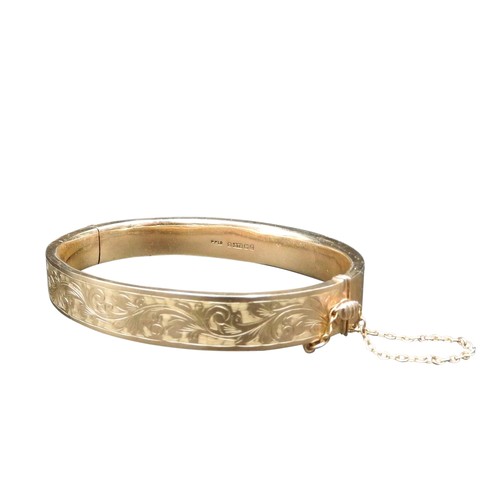 534 - A 9CT GOLD SLAVE BANGLE, partially decorated with foliate pattern, stamped .375, 11.5 grams