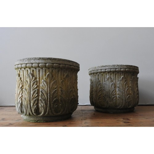 142 - A PAIR OF WEATHERED RECONSTITUTED STONE GARDEN PLANTERS, with repeating foliate pattern, 39 cm high ... 