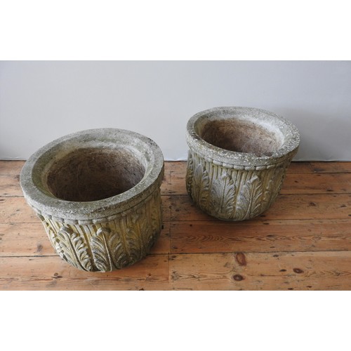 142 - A PAIR OF WEATHERED RECONSTITUTED STONE GARDEN PLANTERS, with repeating foliate pattern, 39 cm high ... 