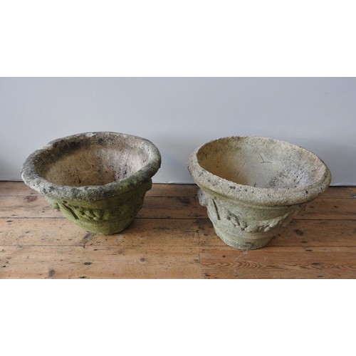 143 - A PAIR OF WEATHERED RECONSTITUTED STONE TAPERED GARDEN PLANTERS, with swag decoration, 36 cm high an... 