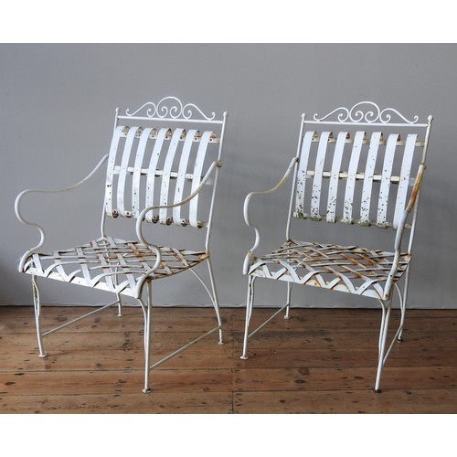 148 - A FRENCH CREAM PAINTED WROUGHT-IRON GARDEN BENCH SEAT AND TWO MATCHING ARMCHAIRS, all with lattice w... 