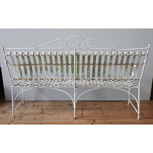 148 - A FRENCH CREAM PAINTED WROUGHT-IRON GARDEN BENCH SEAT AND TWO MATCHING ARMCHAIRS, all with lattice w... 