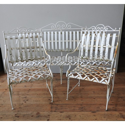 148 - A FRENCH CREAM PAINTED WROUGHT-IRON GARDEN BENCH SEAT AND TWO MATCHING ARMCHAIRS, all with lattice w... 