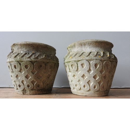 150 - A PAIR OF WEATHERED RECONSTITUTED STONE PLANTERS, with a lattice pattern, 40 cm high, 40 cm diameter