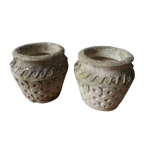 150 - A PAIR OF WEATHERED RECONSTITUTED STONE PLANTERS, with a lattice pattern, 40 cm high, 40 cm diameter