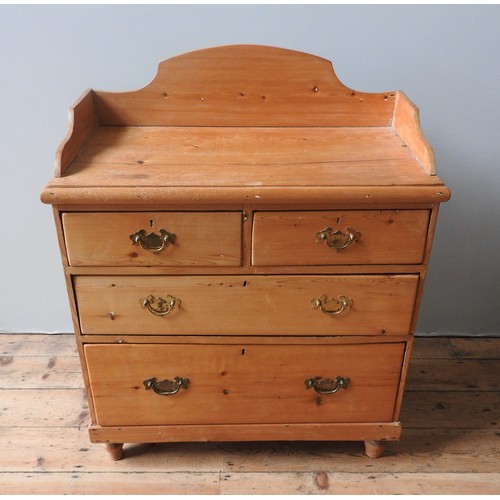 62 - A VICTORIAN PINE GALLERY BACK CHEST OF FOUR DRAWERS, two short drawers over two long drawers, on tur... 