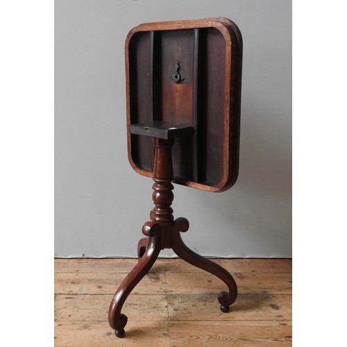 65 - A VICTORIAN MAHOGANY WINE TABLE, the tilting oblong top on a turned pillar, supported by three swept... 