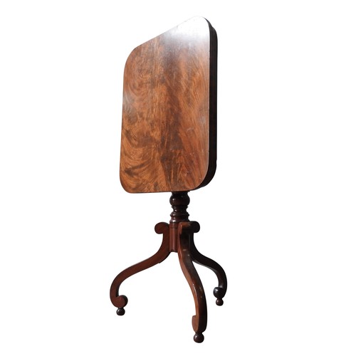 65 - A VICTORIAN MAHOGANY WINE TABLE, the tilting oblong top on a turned pillar, supported by three swept... 