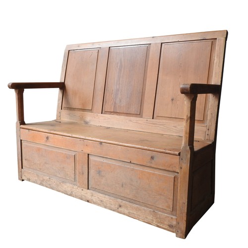 72 - A 19TH CENTURY PINE SETTLE, with three panel back, lift-top seat and open rail arms, 106 x 132 x 45 ... 