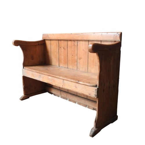 73 - A 19TH CENTURY PINE PEW, with swept scroll arms 85 x 124 x 43 cm