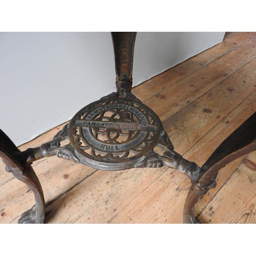 74 - A VINTAGE CAST-IRON PUB TABLE WITH CIRCULAR TOP, with Brittania decoration to the top of the legs, t... 