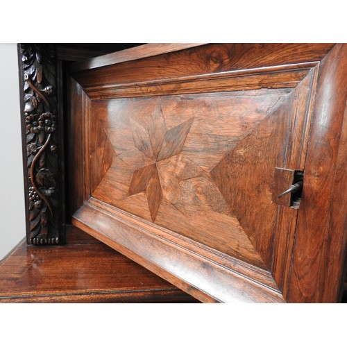 76 - A 18TH CENTURY AUSTRIAN WALNUT SHRANK,  in two sections, with parquetry door panels, long frieze dra... 