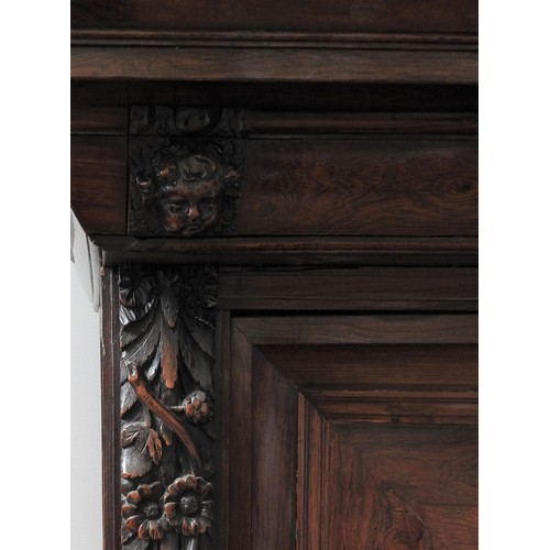 76 - A 18TH CENTURY AUSTRIAN WALNUT SHRANK,  in two sections, with parquetry door panels, long frieze dra... 