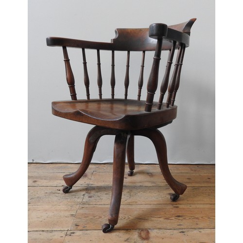 78 - A 19TH CENTURY MAHOGANY REVOLVING DESK CHAIR, the bow back top rail supported by turned pillars, on ... 