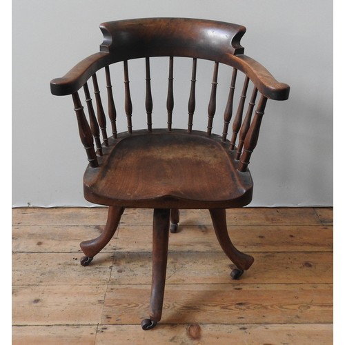 78 - A 19TH CENTURY MAHOGANY REVOLVING DESK CHAIR, the bow back top rail supported by turned pillars, on ... 