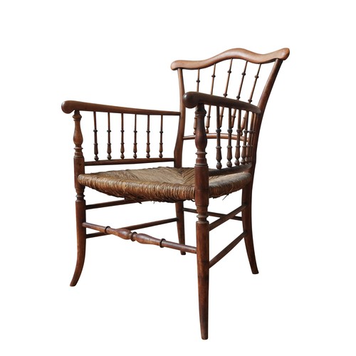 79 - A 19TH CENTURY RUSH SEAT ELBOW CHAIR, with a serpentine top rail supported by turned spindles, on fo... 