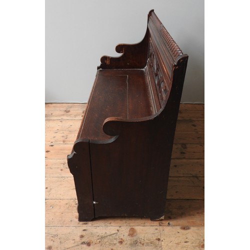 80 - A 19TH CENTURY OAK PEW / BENCH SEAT, with rope twist top rail, foliate carved back panel and lift-to... 